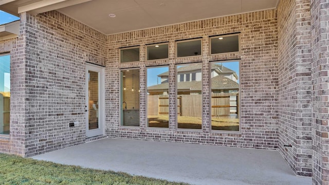 entrance to property featuring a patio area