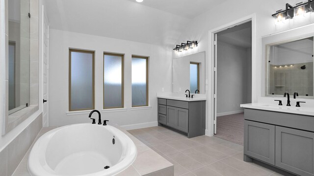 bathroom featuring tile patterned flooring, vanity, and separate shower and tub