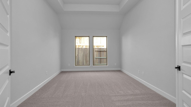 unfurnished room with light carpet and vaulted ceiling