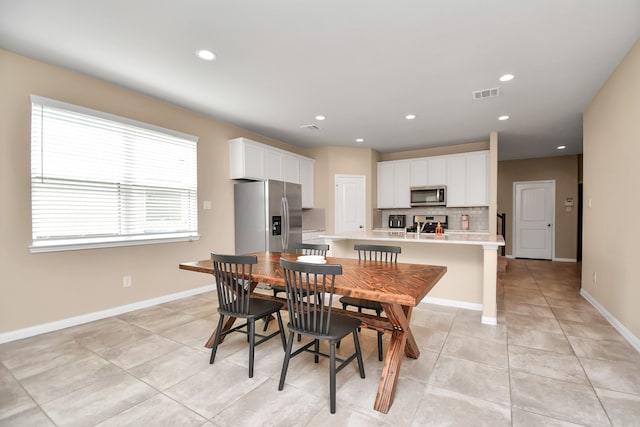 dining space featuring light tile patterned floors