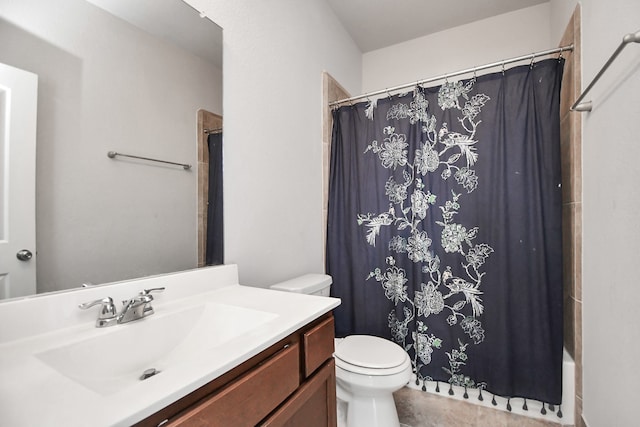 bathroom with tile patterned flooring, vanity, and toilet