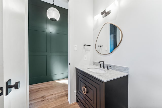 bathroom with hardwood / wood-style floors and vanity