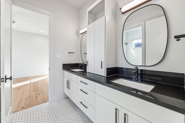 bathroom featuring vanity, ceiling fan, and wood-type flooring