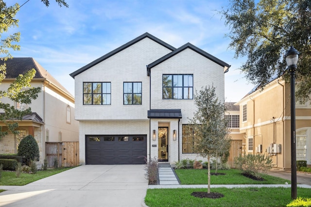 view of front of home featuring a garage and a front lawn