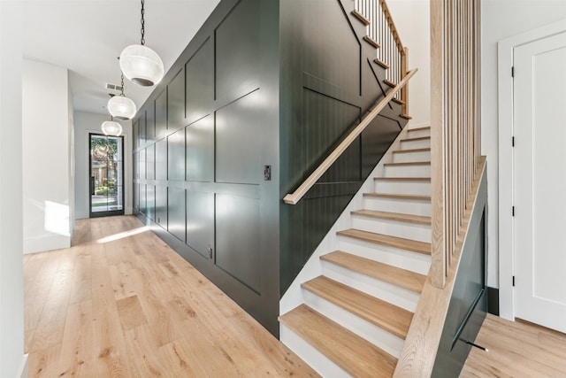 staircase with hardwood / wood-style flooring