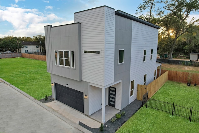 view of home's exterior featuring a yard and a garage