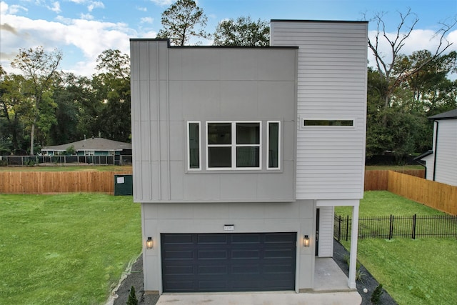 contemporary house with a garage and a front yard