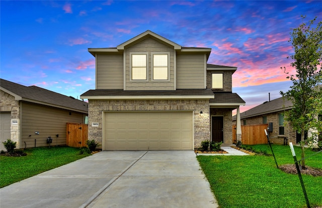 view of front of house featuring a yard and a garage