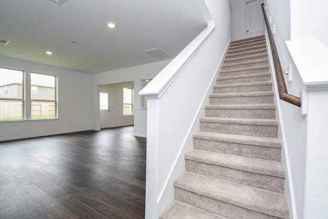 stairs with hardwood / wood-style floors