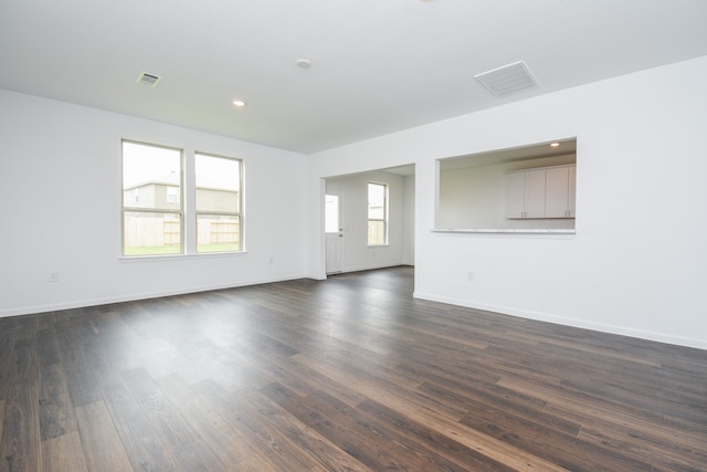 spare room featuring dark hardwood / wood-style flooring