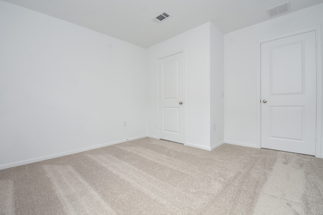 spare room with light colored carpet