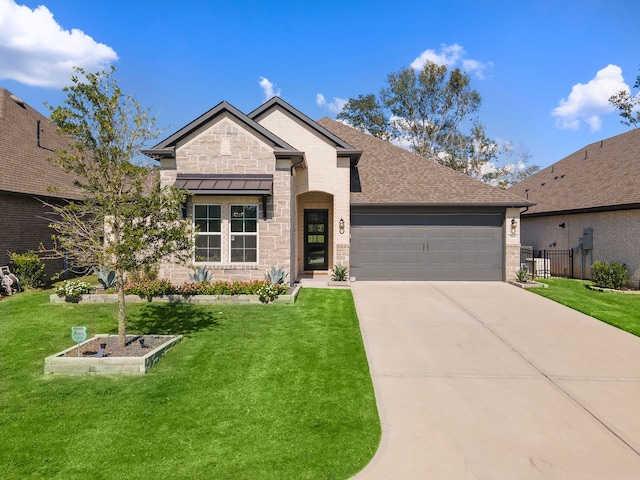 view of front of house with a front yard and a garage