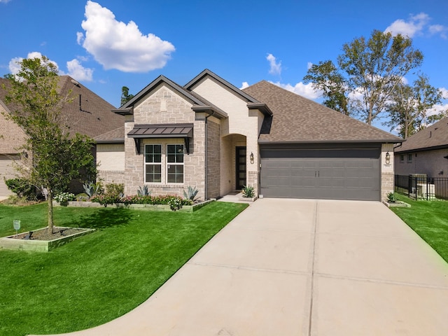 view of front of home featuring a garage and a front lawn