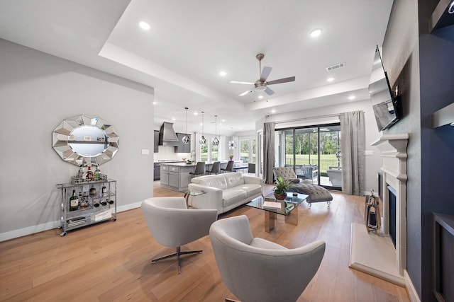 living room featuring ceiling fan and light wood-type flooring