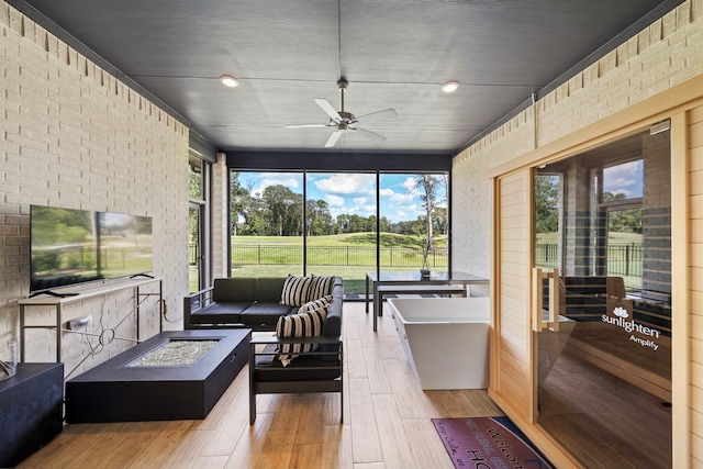 sunroom featuring a wealth of natural light and ceiling fan