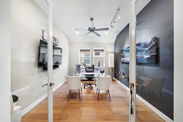 home office with hardwood / wood-style floors, ceiling fan, vaulted ceiling, and french doors