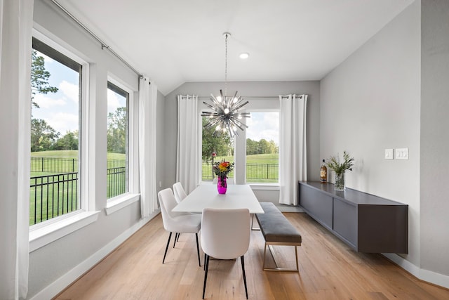 dining room featuring a chandelier, light hardwood / wood-style flooring, and a wealth of natural light