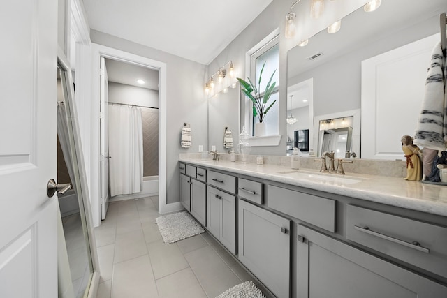 bathroom featuring tile patterned flooring, vanity, and shower / tub combo with curtain