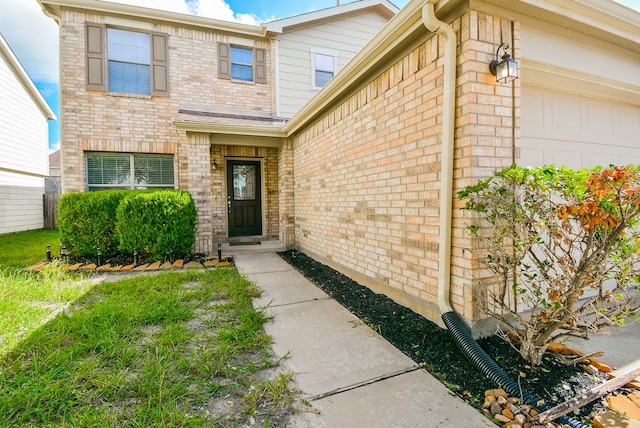 view of exterior entry with a garage