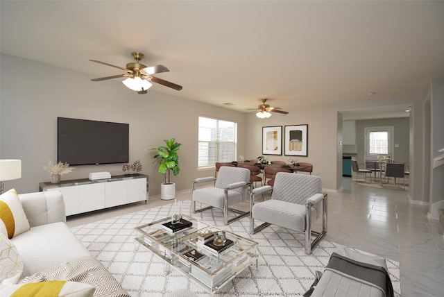 living room featuring a wealth of natural light and ceiling fan