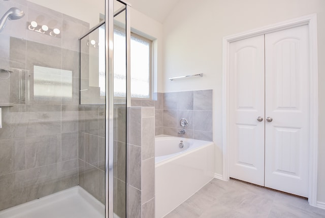 bathroom with tile patterned floors and plus walk in shower