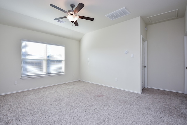 carpeted spare room with ceiling fan and vaulted ceiling