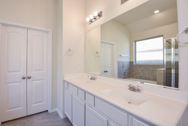 bathroom with tile patterned flooring, vanity, vaulted ceiling, and an enclosed shower