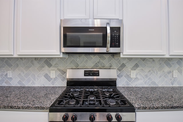 kitchen featuring white cabinets, appliances with stainless steel finishes, and tasteful backsplash