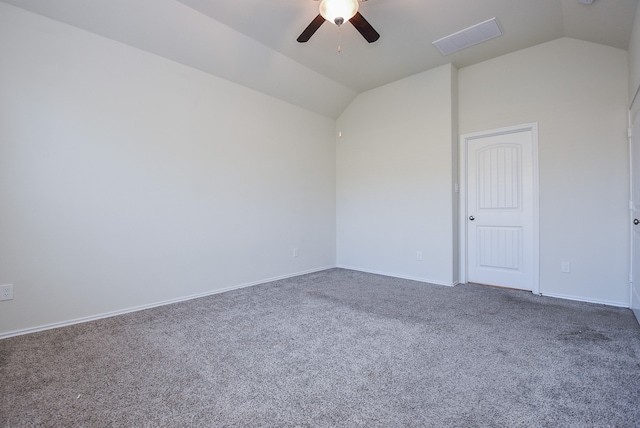 unfurnished room featuring dark colored carpet, vaulted ceiling, and ceiling fan