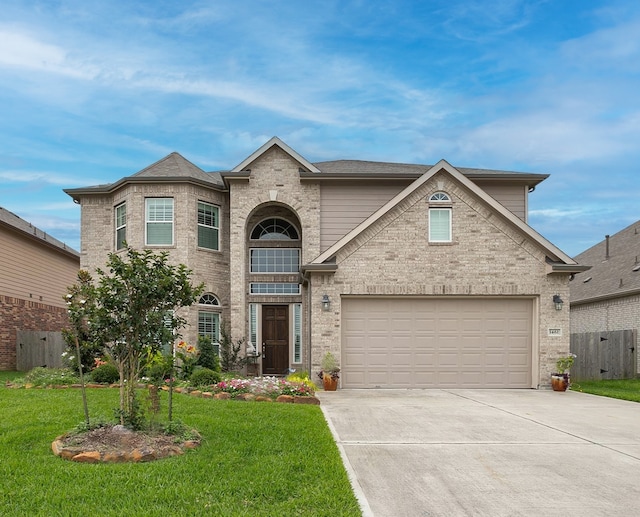 view of front of house with a front lawn and a garage