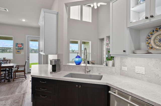 kitchen featuring dishwasher, a healthy amount of sunlight, white cabinetry, and sink