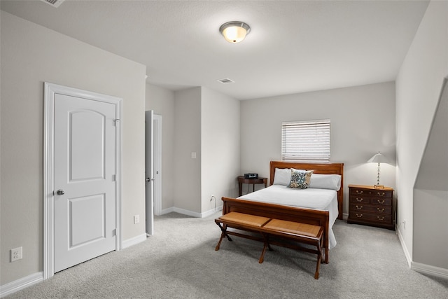 bedroom featuring light carpet