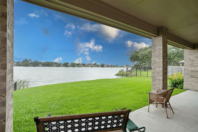 view of yard with a water view and a patio