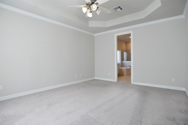 unfurnished room featuring ceiling fan, crown molding, light carpet, and a tray ceiling