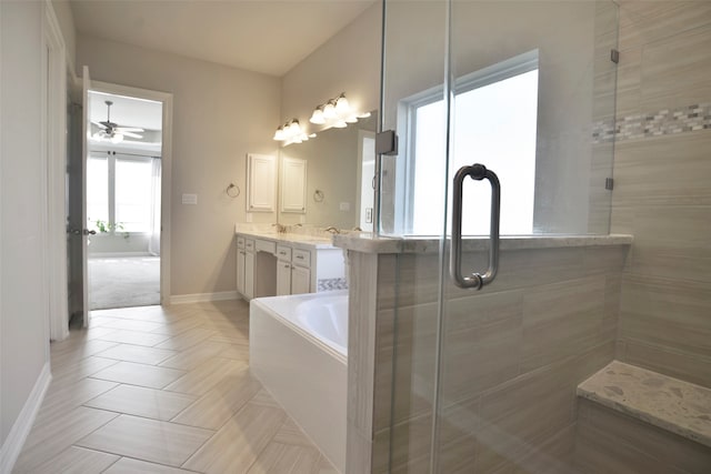 bathroom with ceiling fan, separate shower and tub, and vanity