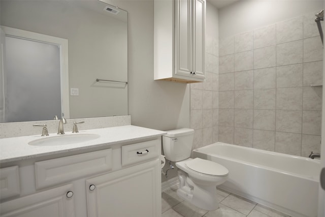 full bathroom with tile patterned floors, vanity, toilet, and tiled shower / bath combo