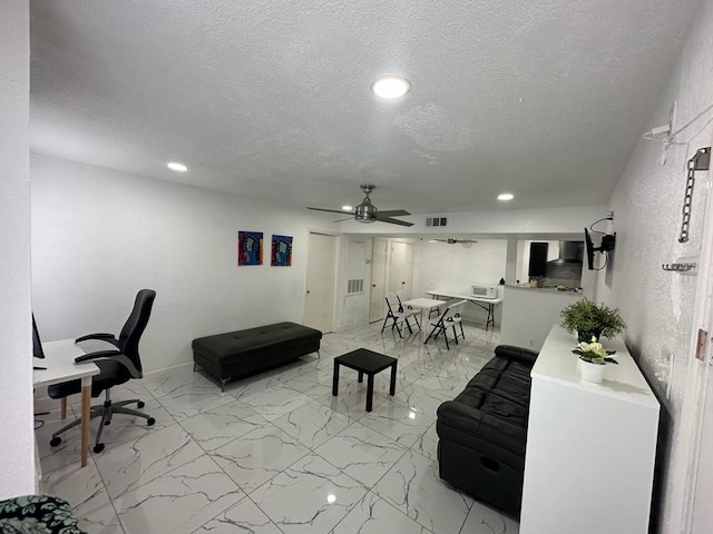 office area featuring a textured ceiling and ceiling fan