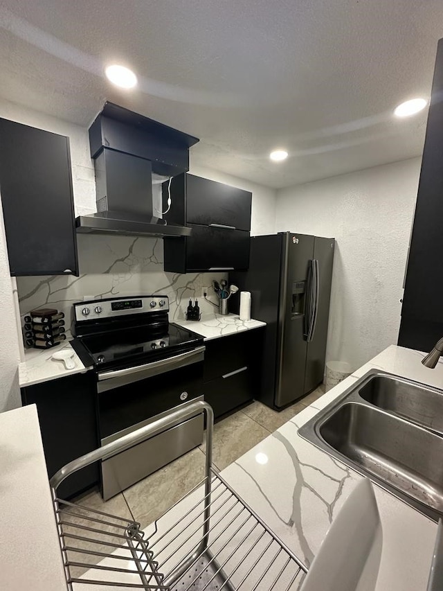 kitchen featuring backsplash, ventilation hood, sink, light tile patterned floors, and appliances with stainless steel finishes