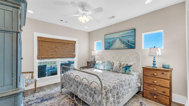 bedroom with ceiling fan and dark wood-type flooring