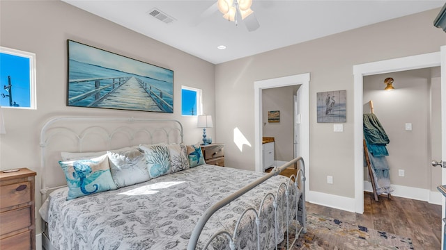 bedroom with dark hardwood / wood-style flooring, ceiling fan, and ensuite bathroom