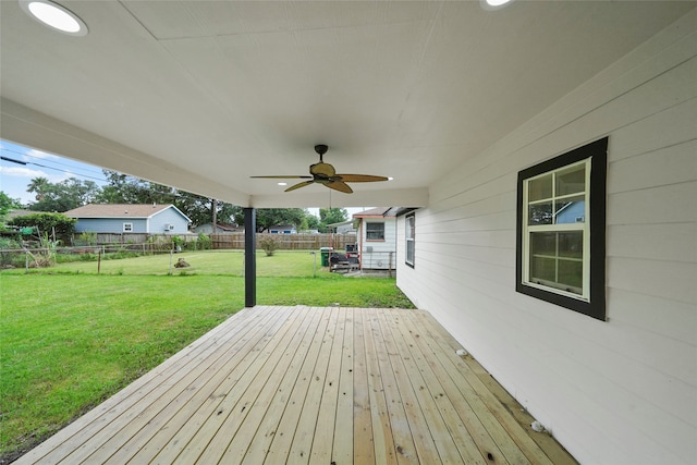 wooden deck featuring a yard and ceiling fan