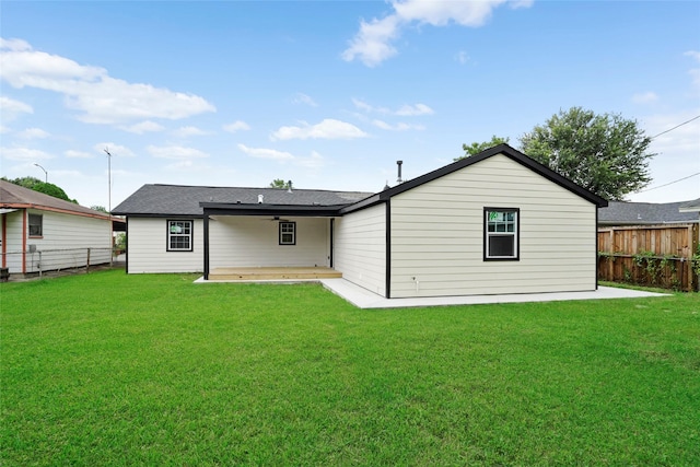 back of house featuring a yard and a patio area