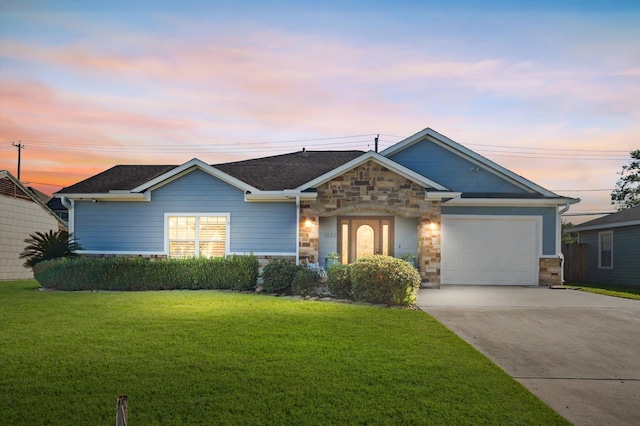 view of front of home with a lawn and a garage