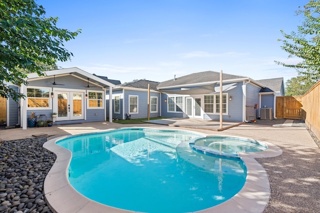 view of pool featuring ceiling fan, french doors, cooling unit, an in ground hot tub, and a patio