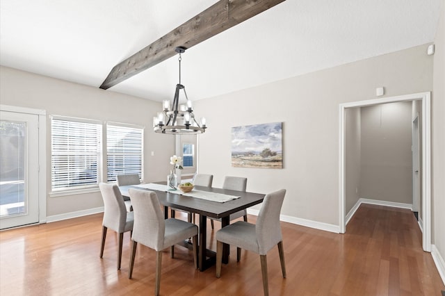 dining area with hardwood / wood-style flooring, vaulted ceiling with beams, and an inviting chandelier