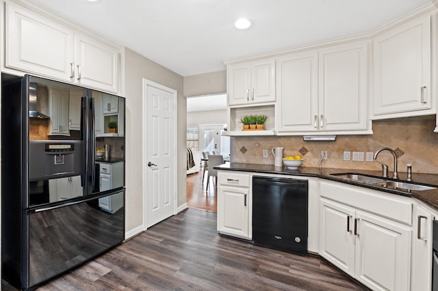 kitchen with white cabinets, dark hardwood / wood-style floors, and black dishwasher