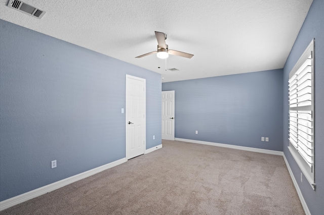 empty room featuring light carpet and ceiling fan