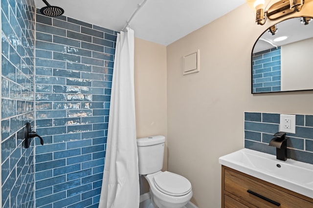 bathroom featuring vanity, toilet, and curtained shower