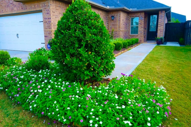 exterior space featuring a garage and a front lawn