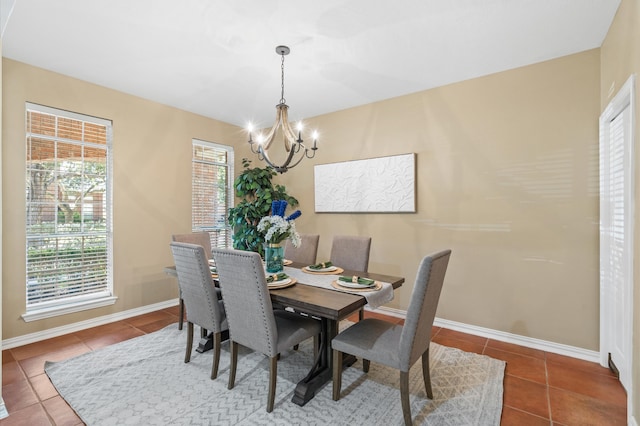 dining area featuring an inviting chandelier, tile patterned floors, and plenty of natural light